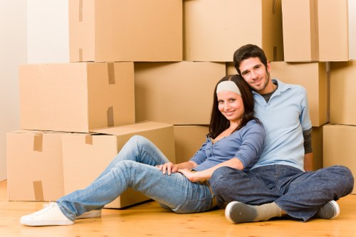 Movers carrying household items through a Uxbridge property