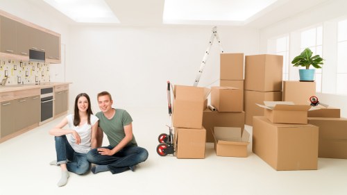 Packed moving boxes and furniture ready for van transport